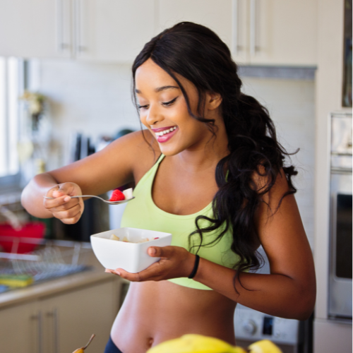 An image of a woman happily eating her food while practicing mindful eating.