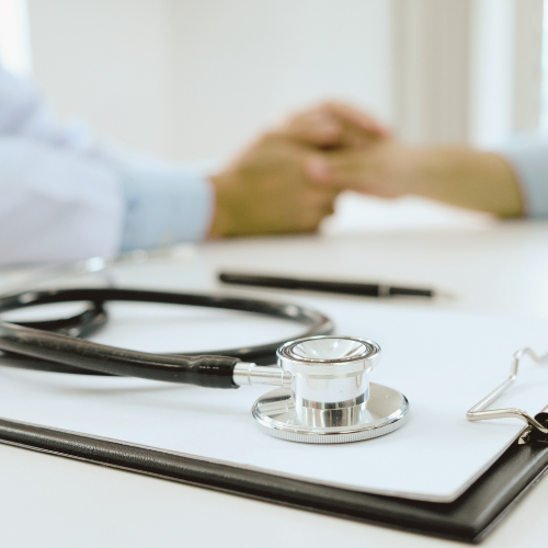 An image of a stethoscope and notepad during a doctors visit.