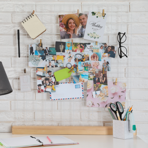 White desk against white brick wall with wellness motivation board.