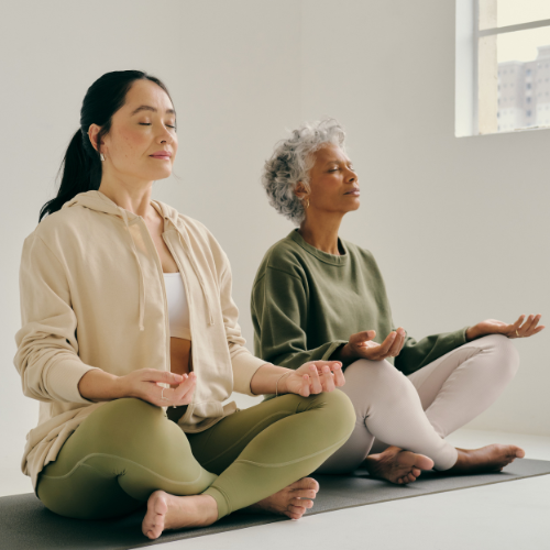 Two women practicing yoga or meditating.